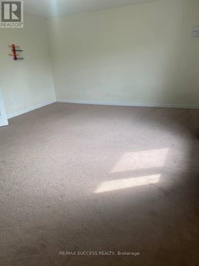 Brantford apartment for rent - A room with a carpet floor and a fire extinguisher on the wall.