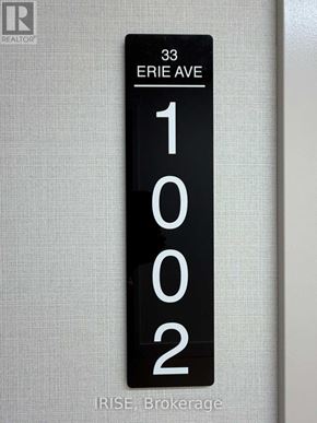Brantford condo for rent - A black and white sign with the numbers 1002 on it.