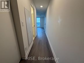 Brantford condo for rent - A long hallway with a door at the end.