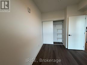 Brantford condo for rent - A room with a brokerage sign on the wall.