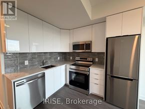 Brantford condo for rent - A kitchen with white cabinets and stainless steel appliances.