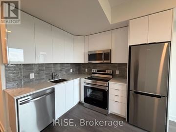 Brantford condo for rent - A kitchen with white cabinets and stainless steel appliances.
