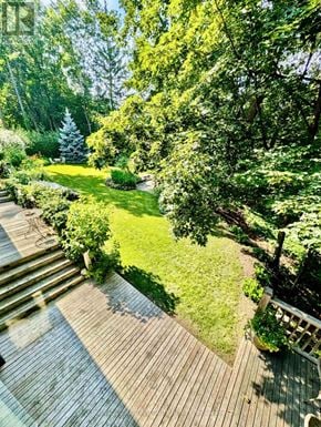 Ottawa apartment for rent - A deck leads down to a lush green lawn.