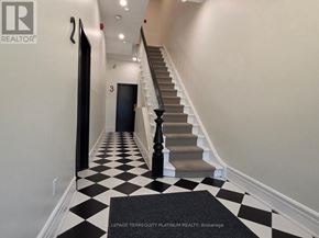 Toronto (Little Portugal) multi-family for rent - A hallway with a black and white checkered floor.