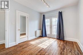 Toronto (Rosedale-Moore Park) apartment for rent - A room with wooden floors and white walls, with a door and a window.