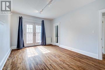 Toronto (Rosedale-Moore Park) apartment for rent - A room with wooden flooring and a large window with curtains.