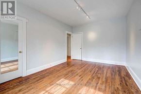 Toronto (Rosedale-Moore Park) apartment for rent - A room with wooden flooring and white walls, with a door on the right and a window on the left.