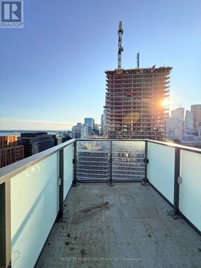 Toronto (Waterfront Communities) condo for rent - A construction site with a crane and a building under construction.