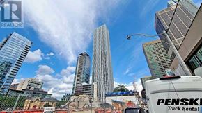 Toronto (Annex) condo for rent - A cityscape with a Penske Truck Rental truck in the foreground.