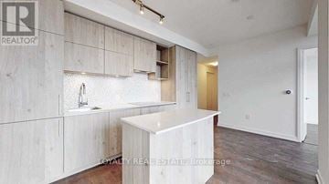 Toronto (Annex) condo for rent - A white kitchen with a sink and a counter.