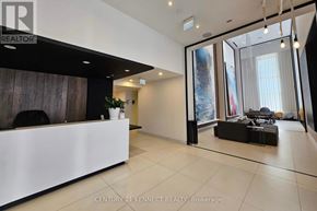 Toronto (Waterfront Communities) condo for rent - A realtor's office with a white reception desk and a large window.