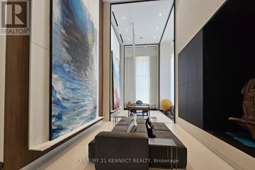 Toronto (Waterfront Communities) condo for rent - A modern living room with a large painting on the wall and a long hallway.