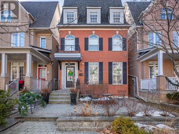 Toronto (The Beaches) apartment for rent - A red brick house with a black iron fence and a small garden in front.