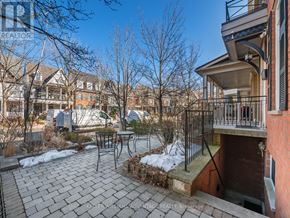 Toronto (The Beaches) apartment for rent - A brick patio with a table and chairs is in front of a house.