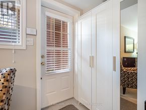 Toronto (The Beaches) apartment for rent - A white door with a window above it and a chair with a polka dot pattern to the left.