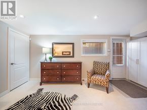 Toronto (The Beaches) apartment for rent - A room with a zebra rug, a wooden dresser, a chair, and a painting on the wall.