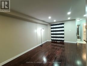 Ajax (Central West) apartment for rent - A room with a striped curtain and a floor lamp.