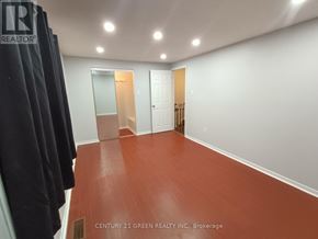 Ajax (Central West) apartment for rent - A room with a red floor and white walls.