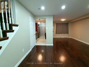 Ajax (Central West) apartment for rent - A room with wooden floors and a staircase leading to the second floor.