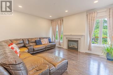 Brampton (Credit Valley) apartment for rent - A living room with a leather couch and a fireplace.