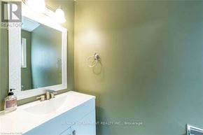 Hamilton (Stoney Creek Mountain) apartment for rent - A bathroom with a sink, mirror, and towel rack.