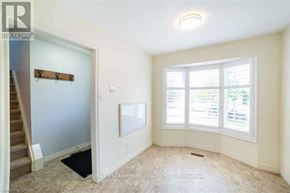 Hamilton (Stoney Creek Mountain) apartment for rent - A room with a window and a door leading to a staircase.