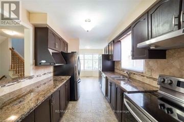 Hamilton (Stoney Creek Mountain) apartment for rent - A kitchen with dark brown cabinets and granite countertops.