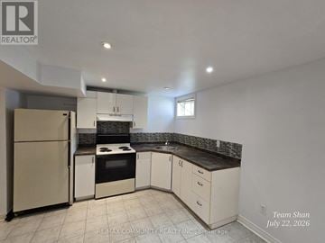Welland (N. Welland) apartment for rent - A kitchen with white cabinets and a refrigerator.
