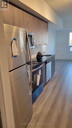 Brantford condo for rent - A stainless steel refrigerator with a note attached to it in a kitchen.