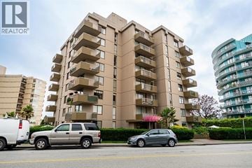 West Vancouver apartment for rent - A tall apartment building with a car parked in front of it.