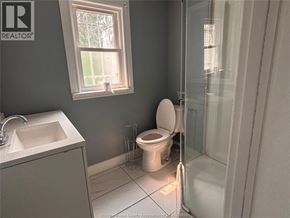 Windsor apartment for rent - A bathroom with a toilet, sink, and shower.