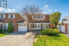 Toronto (L'amoreaux) apartment for rent - A house with a brick facade and a white garage door.