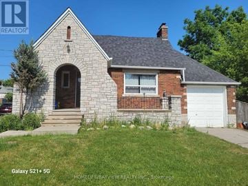 Markham (Old Markham Village) apartment for rent - A house with a stone facade and a white garage door is for sale.