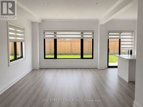 Barrie (Innis-Shore) apartment for rent - A realtor photo of a room with a large window and a wooden floor.