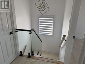 Barrie (Innis-Shore) apartment for rent - A white door with a black handle and a glass window above it.