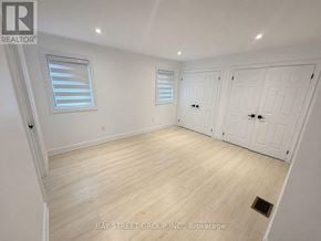 Barrie (Innis-Shore) apartment for rent - A room with white walls, wooden flooring, and two doors.
