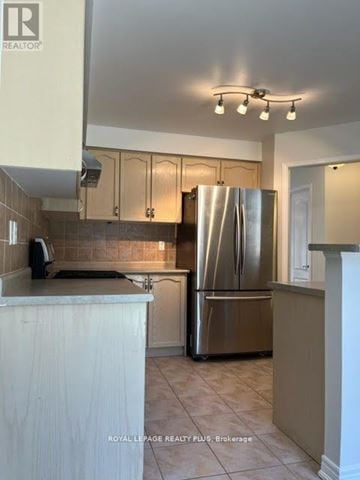 Mississauga (Churchill Meadows) apartment for rent - A kitchen with a refrigerator, cabinets, and a counter.
