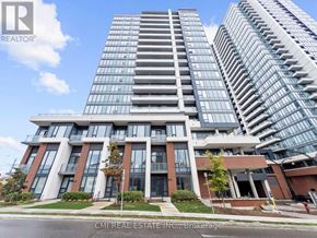 Kitchener condo for rent - A modern multi-story building with a glass facade is shown.