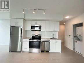 Toronto (Humber Heights) condo for rent - A modern kitchen with white cabinets and stainless steel appliances.