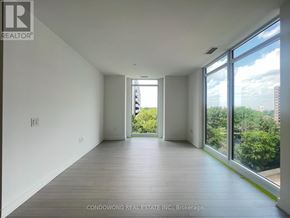 Toronto (Humber Heights) condo for rent - A spacious room with a view of the city through large windows.