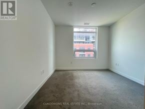Toronto (Humber Heights) condo for rent - Empty room with a window and carpeted floor.