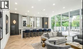 Guelph (St. Patrick's Ward) condo for rent - A living room with a bar area and a couch.