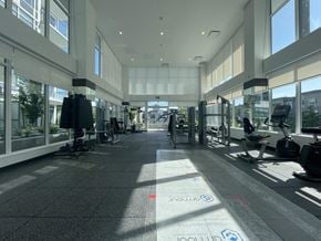 Surrey apartment for rent - A spacious gym with treadmills and exercise equipment.