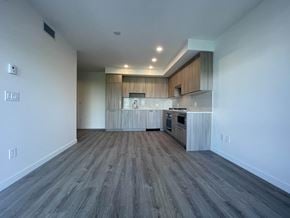 Surrey apartment for rent - A spacious kitchen with wooden floors and a modern design.