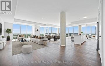 Mississauga (Clarkson) condo for rent - A modern living room with a large window and a view of the city.