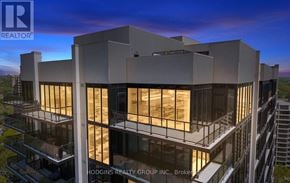 Mississauga (Clarkson) condo for rent - A modern building with a glass facade is under construction by Hodgins Realty Group Inc.