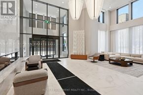Hamilton (Corktown) condo for rent - A spacious lobby with a marble floor and modern furniture.