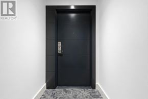 Hamilton (Corktown) condo for rent - A black door with a silver handle and a keypad on the right side.