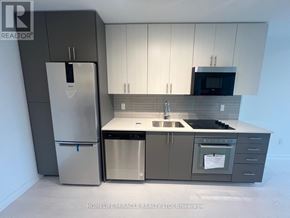 Hamilton (Kirkendall) condo for rent - A kitchen with a refrigerator, microwave, dishwasher, and oven.