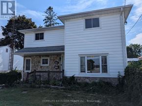 Oshawa (Samac) apartment for rent - A white house with a stone pillar in front.
